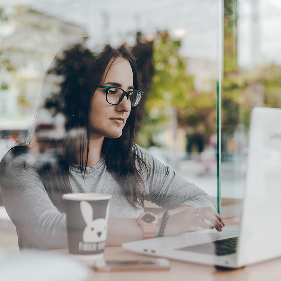 young business woman working at the Cafe and using Laptop